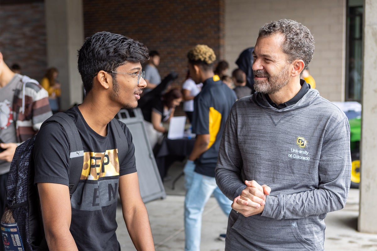 President Saliman speaking to a student