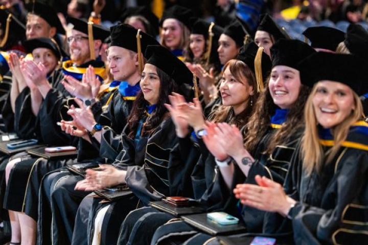 CU grads clapping at Commencement